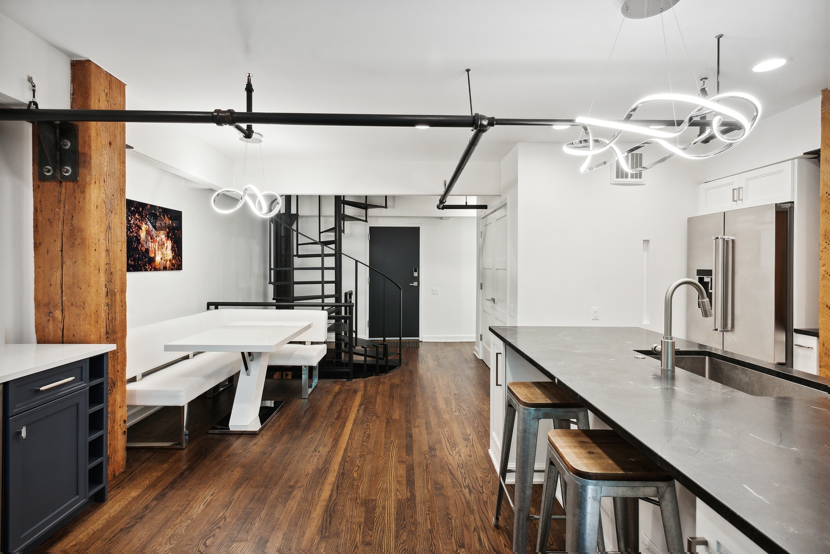 1000 West Washington Boulevard, Unit 148 Chicago, IL 60607 - Photo 9 of 18 a dining room with stainless steel appliances wooden floor and chandelier
