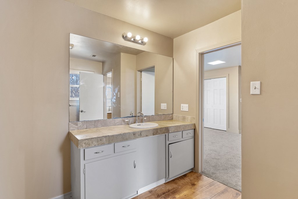1200 North Street Kerrville, TX 78028 - Photo 18 of 50 a bathroom with a granite countertop sink and a mirror