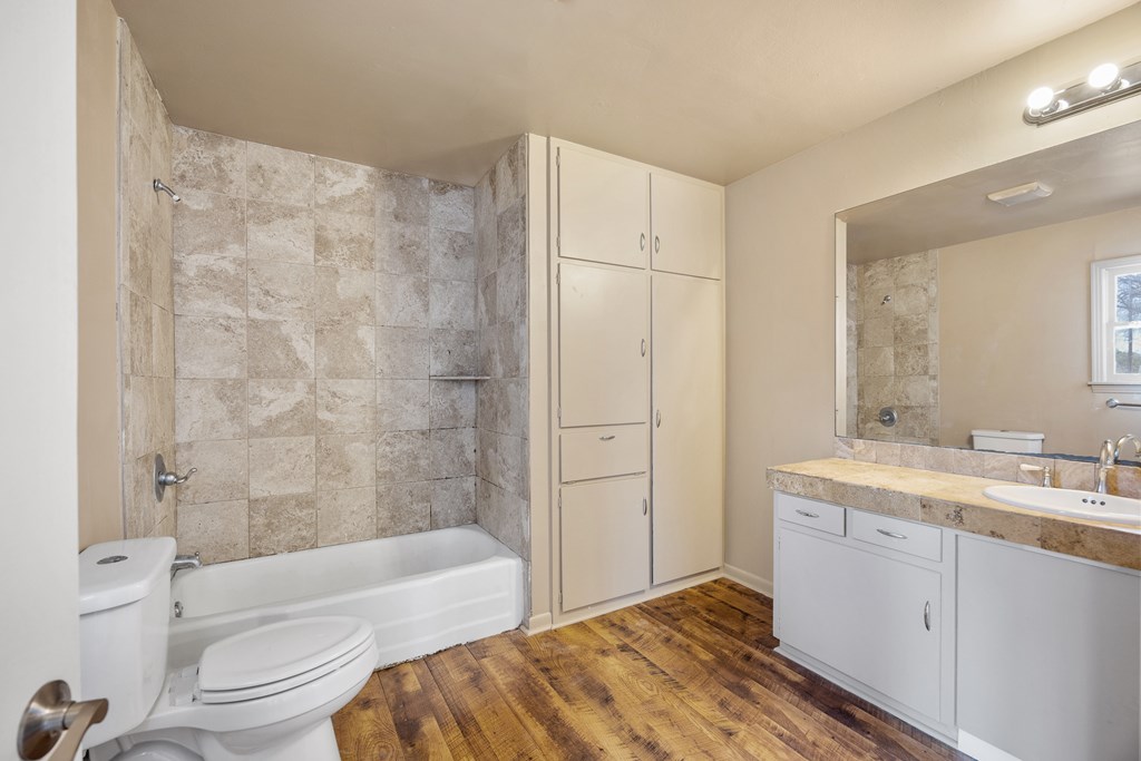 1200 North Street Kerrville, TX 78028 - Photo 19 of 50 a en suite bathroom with a granite countertop sink a toilet and bathtub