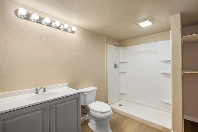 a view of a livingroom with a ceiling fan and window