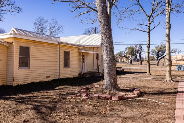 a view of a backyard with large trees