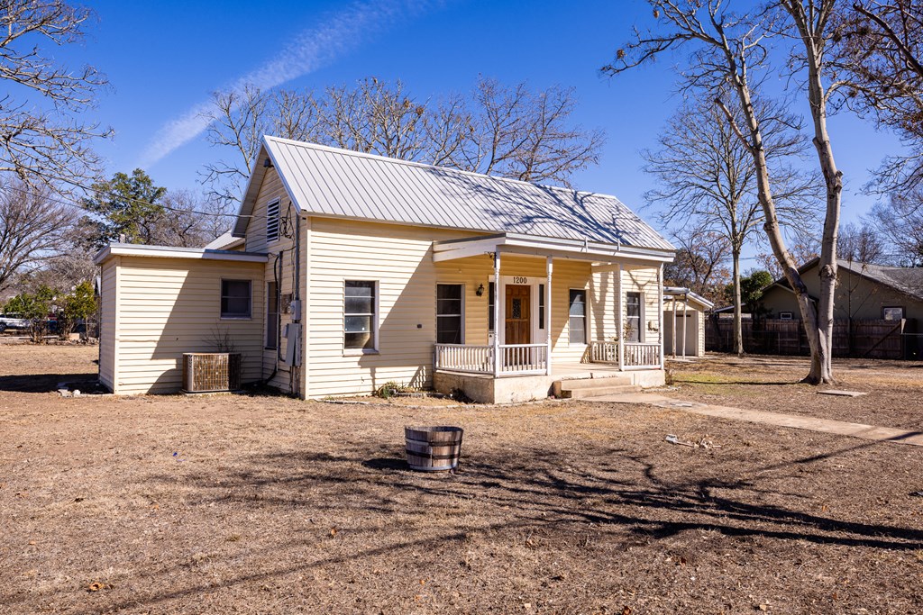 1200 North Street Kerrville, TX 78028 - Photo 3 of 50 a view of a house with a yard covered in snow
