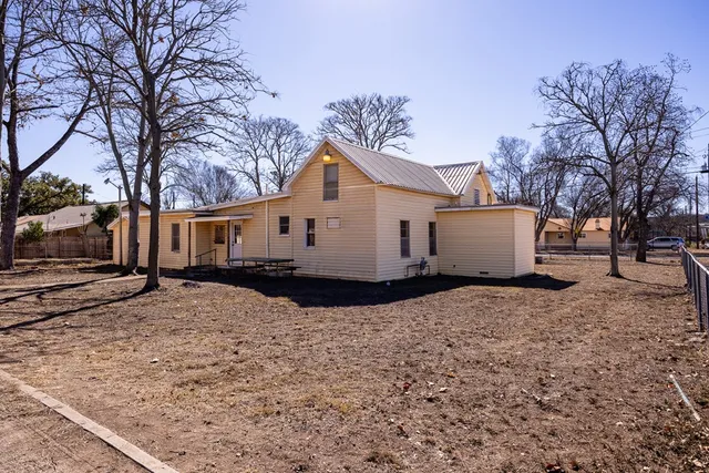 a wooden house with trees in front of it