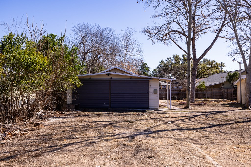 1200 North Street Kerrville, TX 78028 - Photo 37 of 50 a wooden house with trees in front of it