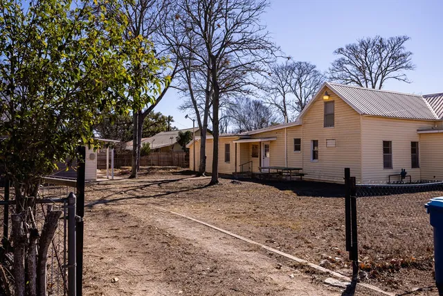 a view of an empty room with wooden ceiling