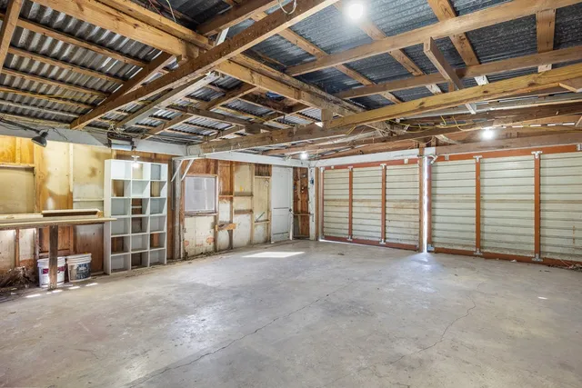 a view of kitchen with granite countertop cabinets and window