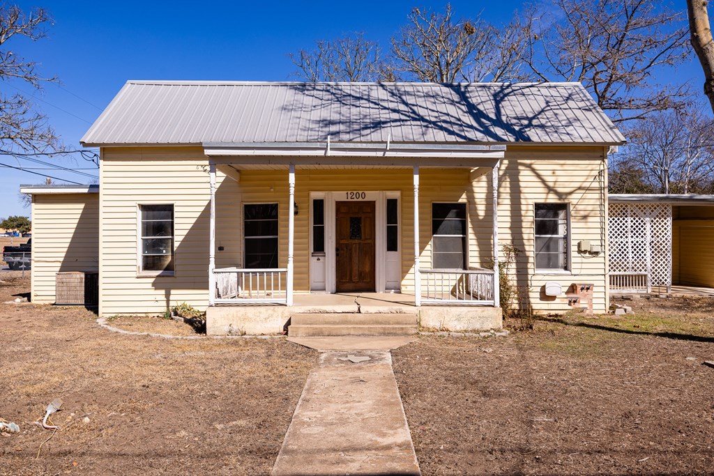1200 North Street Kerrville, TX 78028 - Photo 4 of 50 front view of a brick house with a large window