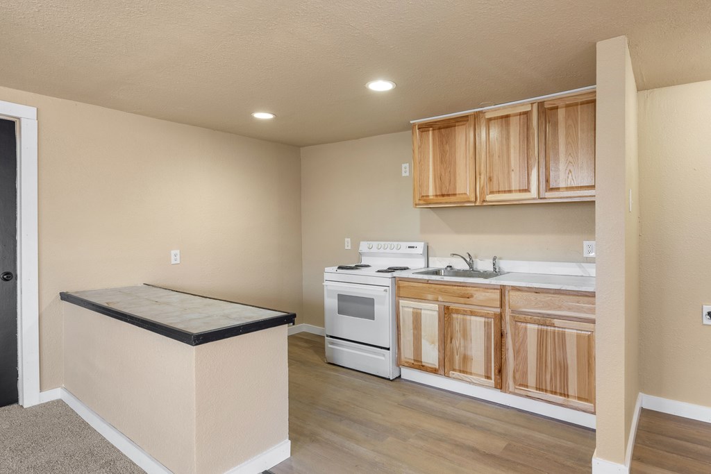 1200 North Street Kerrville, TX 78028 - Photo 46 of 50 a kitchen with stainless steel appliances granite countertop a stove a sink and white cabinets