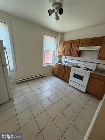 a kitchen with stainless steel appliances a stove a sink and a refrigerator