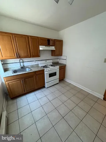 a kitchen with stainless steel appliances a sink window and cabinets