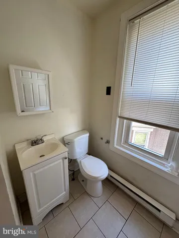 a white toilet sitting next to a bathroom sink