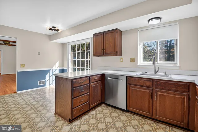 a kitchen with stainless steel appliances granite countertop a sink stove and microwave