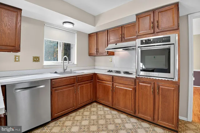 a kitchen with stainless steel appliances a refrigerator and a stove top oven