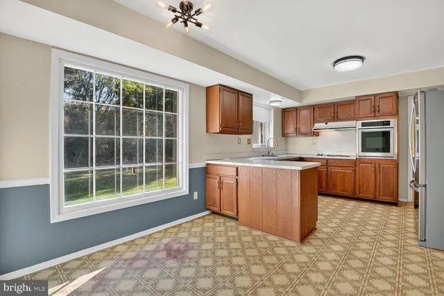a view of a room with a window and a ceiling fan