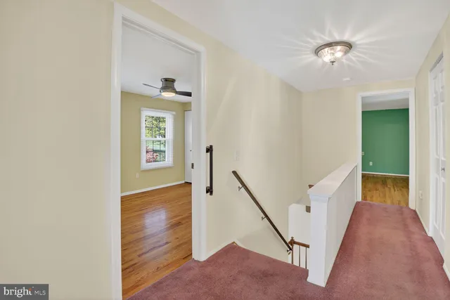 a front view of a house with a garden and trees