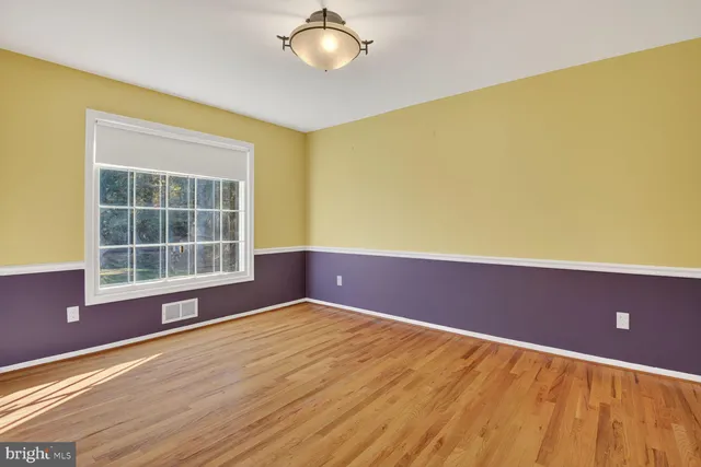 a view of a room with wooden floor and cabinets