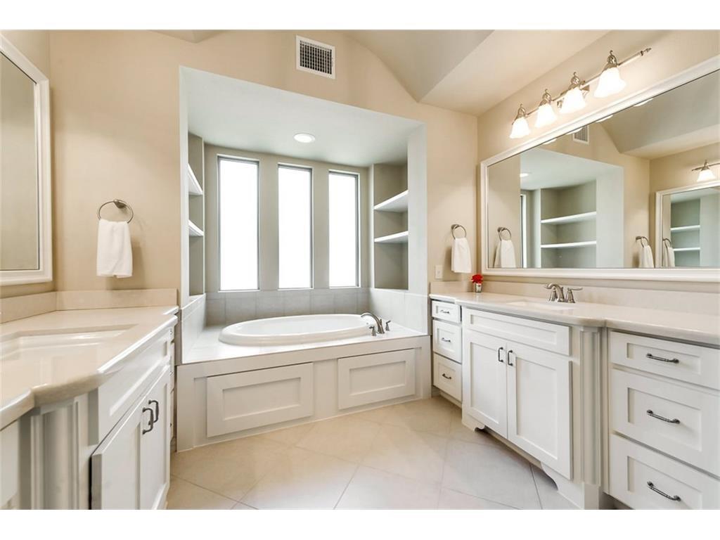 917 Pleasant View Drive Rockwall, TX 75087 - Photo 20 of 27 a bathroom with a granite countertop sink a large mirror and a bathtub