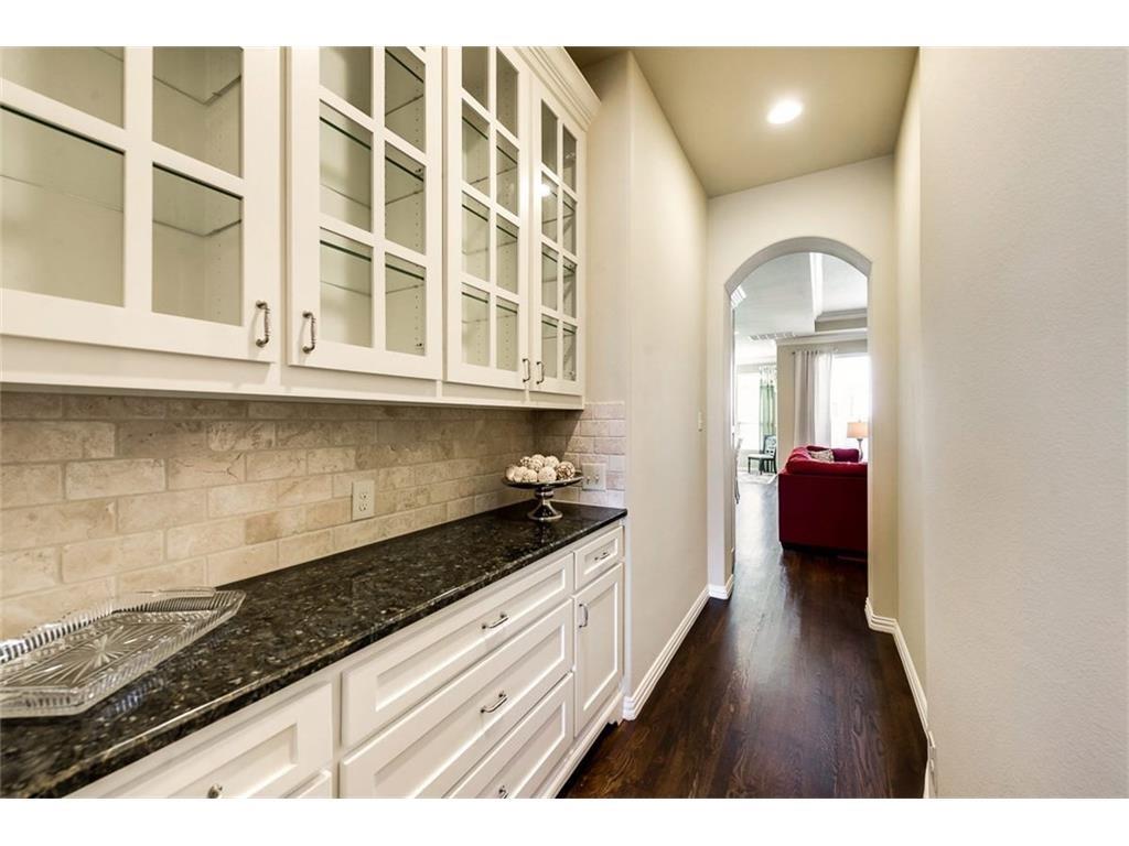 917 Pleasant View Drive Rockwall, TX 75087 - Photo 9 of 27 a kitchen with granite countertop a stove and cabinets