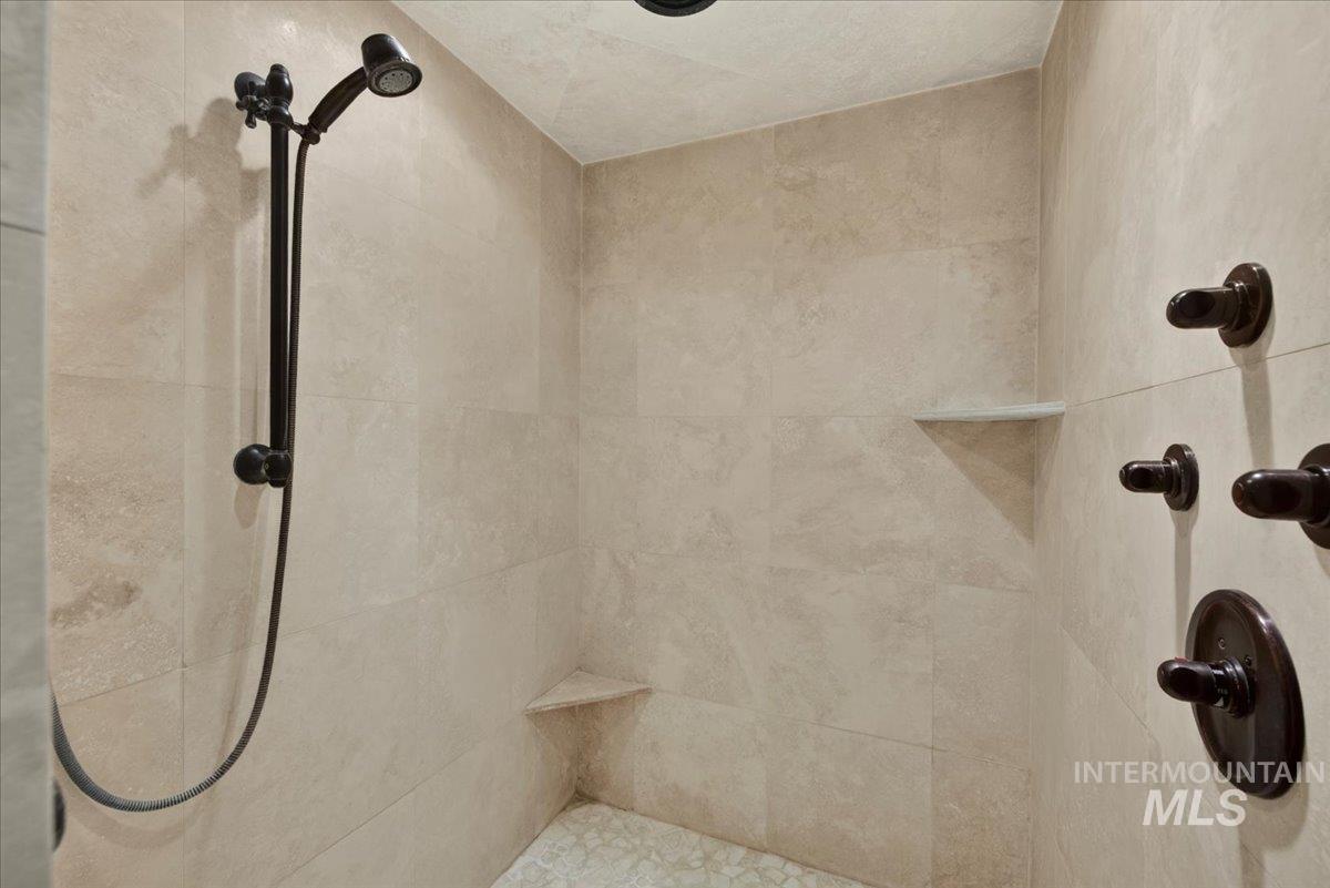414 East Shafer View Drive Meridian, ID 83642 - Photo 23 of 50 Immaculately Clean tiled Walk-in shower with a full body shower jet feature along with a handheld shower fixture, and oil-rubbed bronze hardware