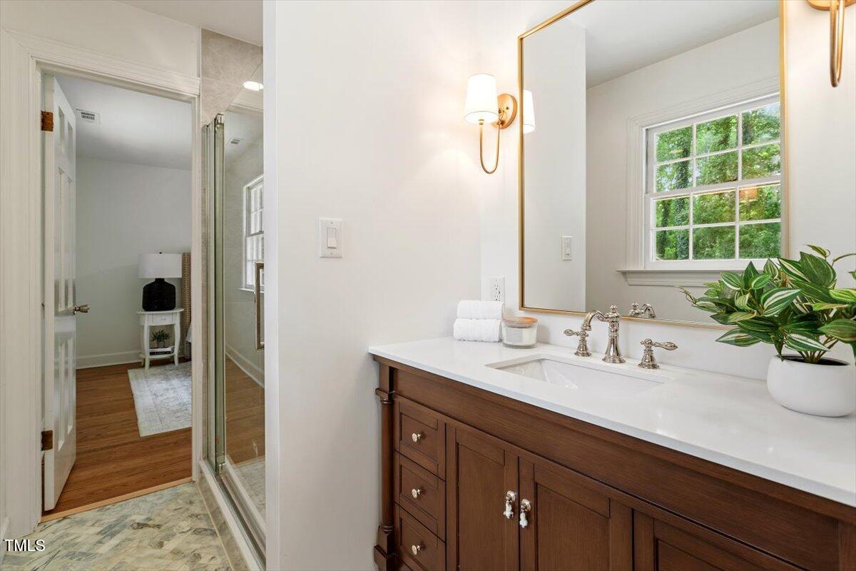 6311 Brandywine Road Raleigh, NC 27607 - Photo 14 of 21 a bathroom with a sink a potted plant and a shower