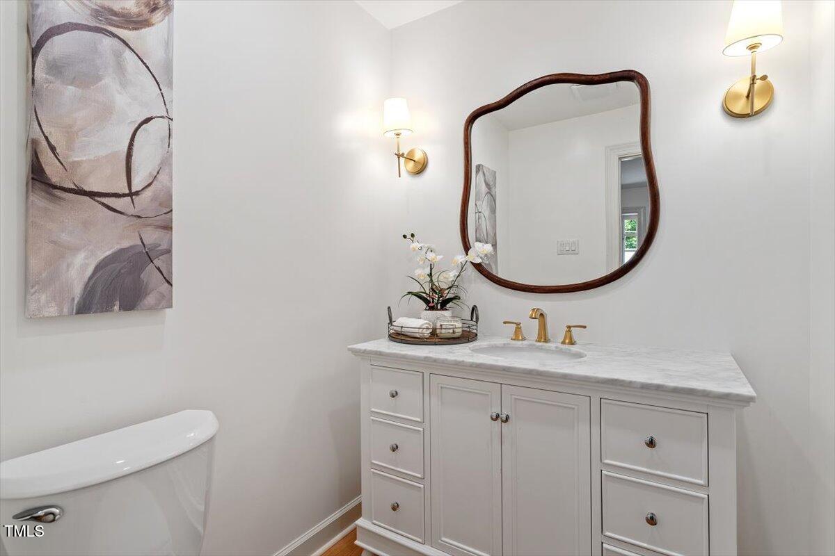 6311 Brandywine Road Raleigh, NC 27607 - Photo 3 of 21 a bathroom with a sink vanity and a mirror