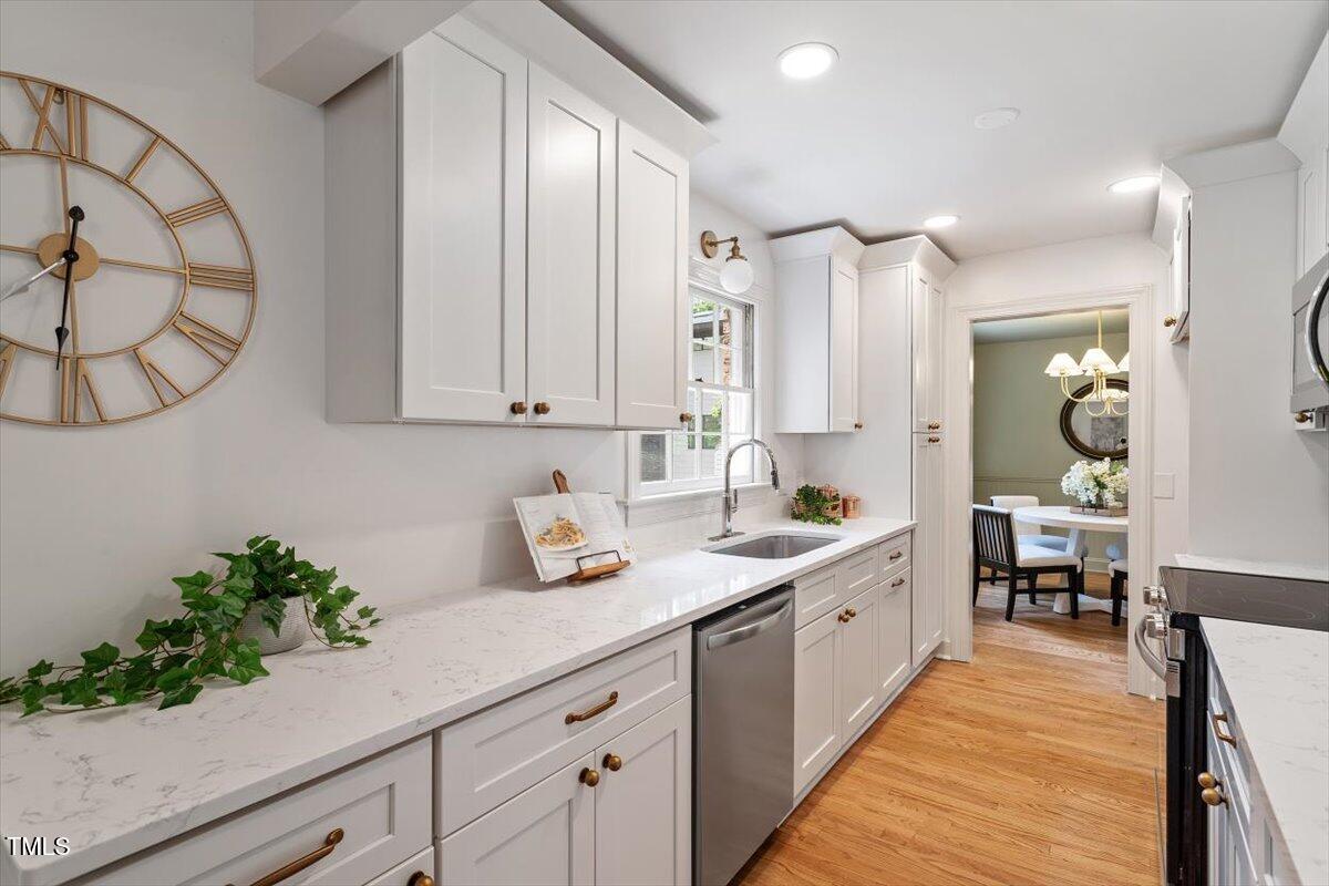 6311 Brandywine Road Raleigh, NC 27607 - Photo 7 of 21 a spacious bathroom with a double vanity sink and a mirror