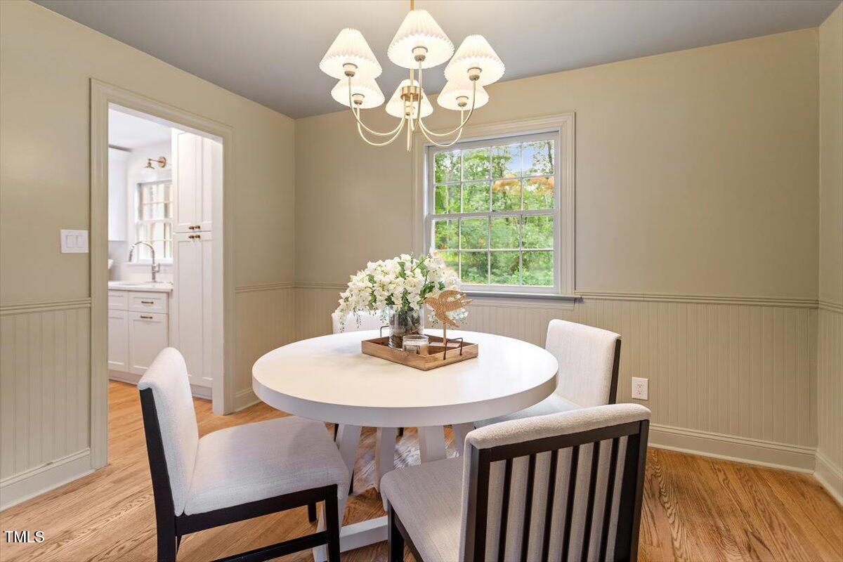 6311 Brandywine Road Raleigh, NC 27607 - Photo 9 of 21 a dining room with furniture a rug and a mirror