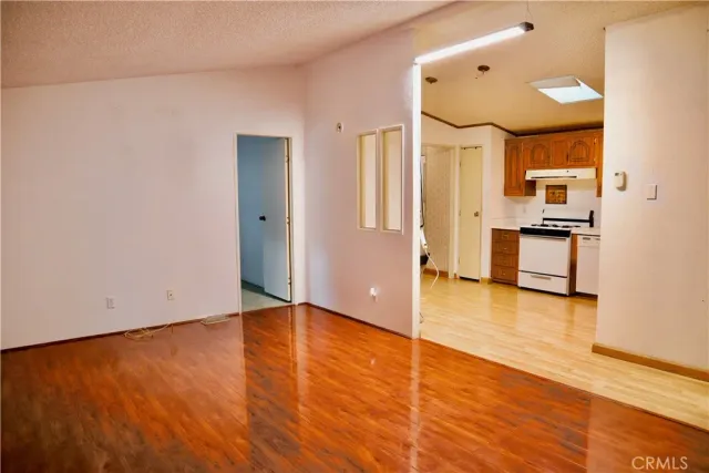 a view of a kitchen with wooden floor and a sink