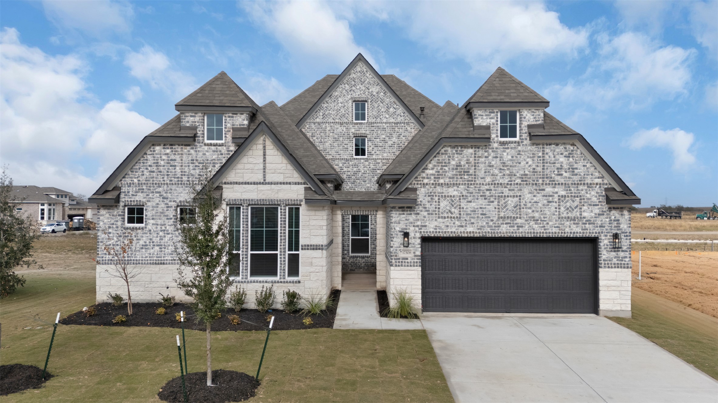 2312 Tobiano Trace Georgetown, TX 78633 - Photo 1 of 33 Contemporary brick and stone facade featuring varied grey brickwork and light stone accents