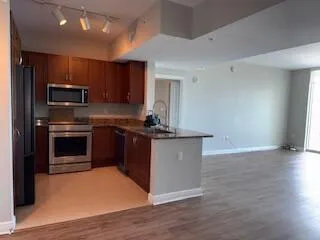 a kitchen with kitchen island stainless steel appliances a stove sink and microwave
