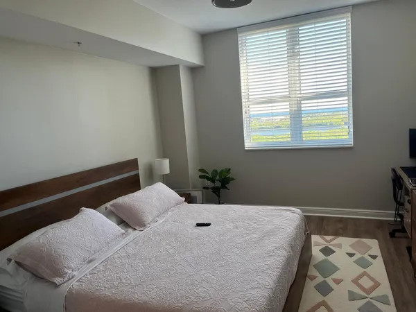 an empty room with wooden floor cabinet and windows
