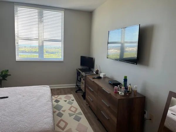 a hallway with a large window and a wooden floor