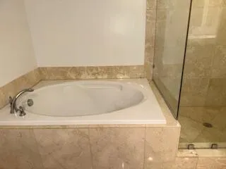 a bathroom with a shower and a bathtub