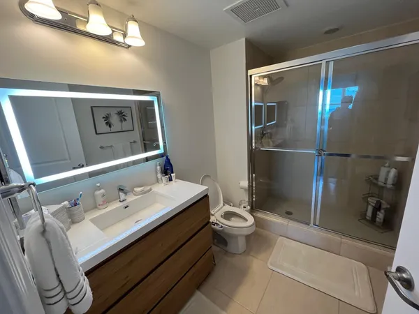 a bathroom view of a shower and a toilet