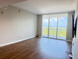 an empty room with wooden floor and a window
