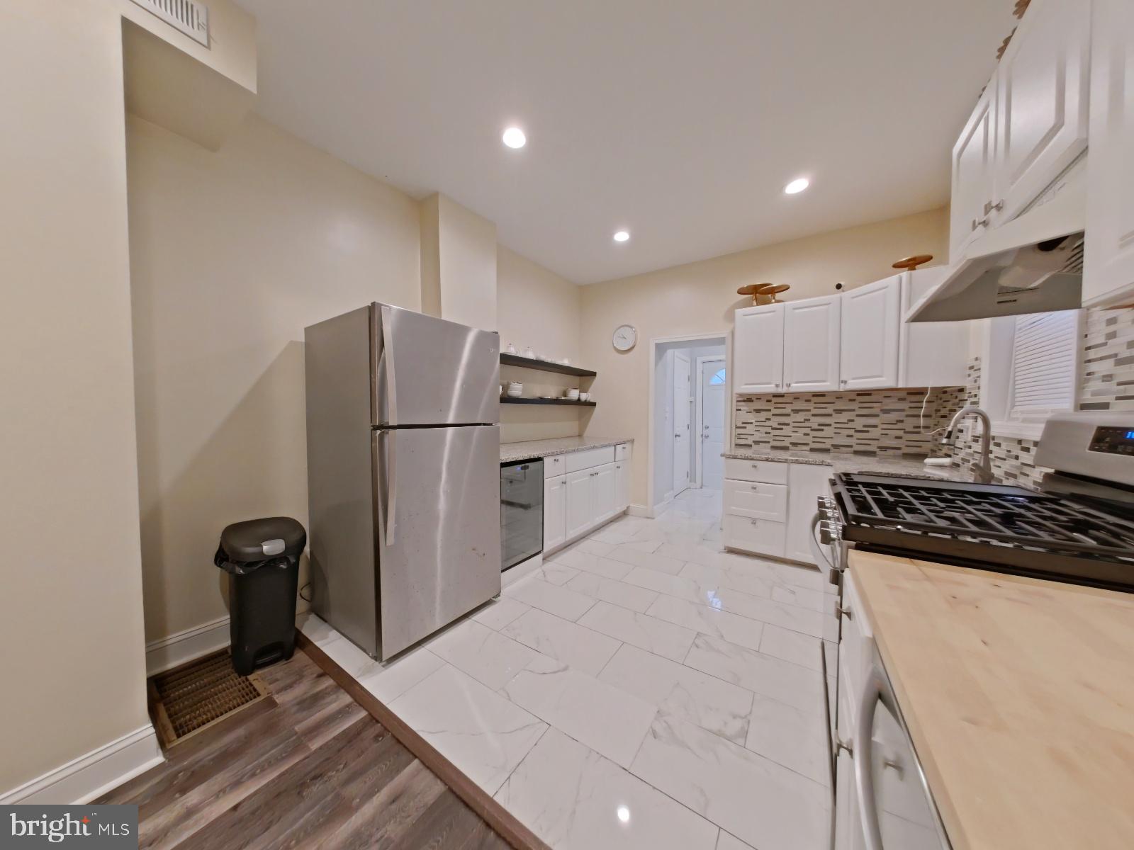 154 North 60th Street Philadelphia, PA 19139 - Photo 13 of 40 a kitchen with stainless steel appliances a refrigerator sink and stove