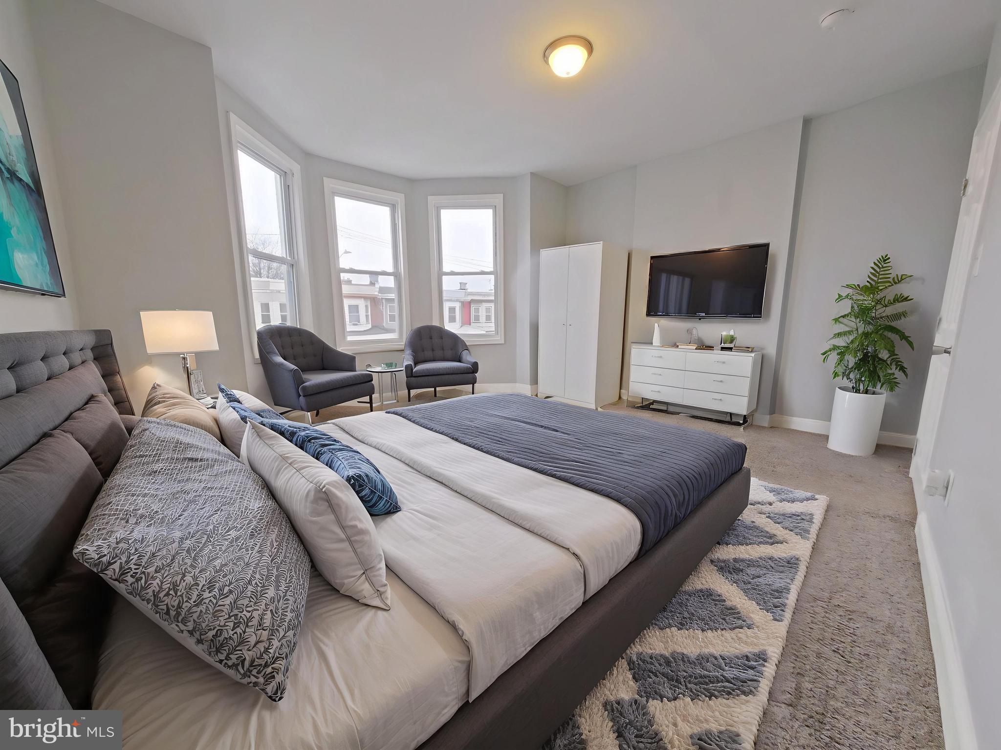 154 North 60th Street Philadelphia, PA 19139 - Photo 2 of 40 a bedroom with a bed and large windows