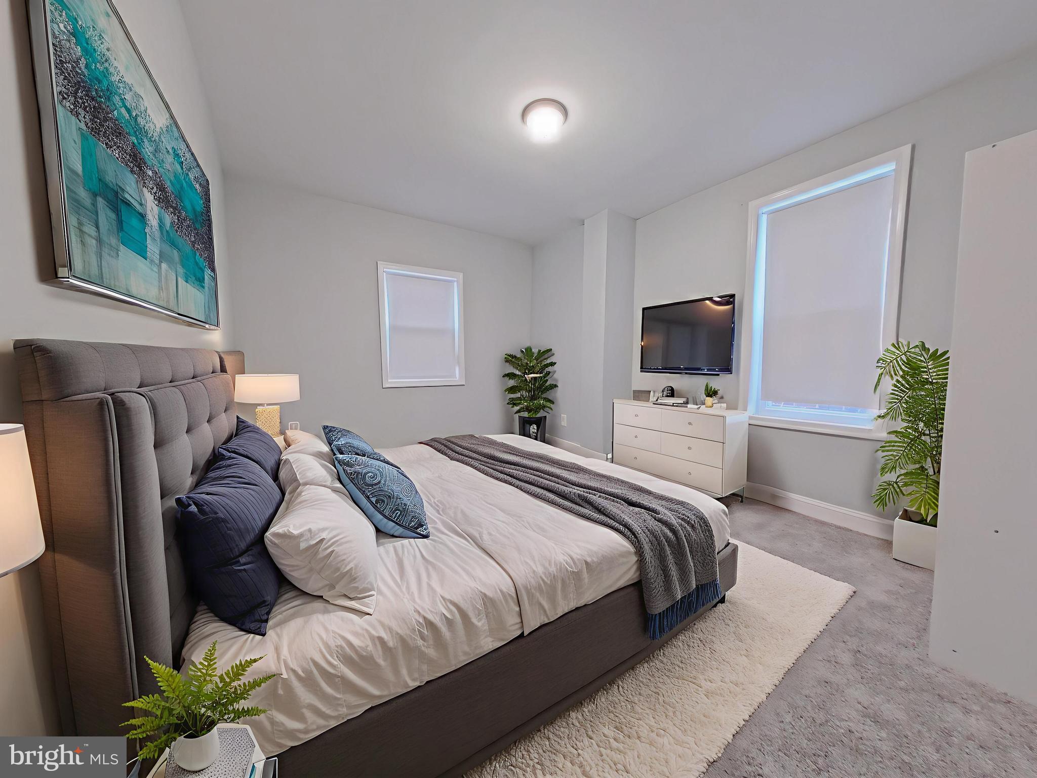 154 North 60th Street Philadelphia, PA 19139 - Photo 4 of 40 a bedroom with a bed and a flat screen tv