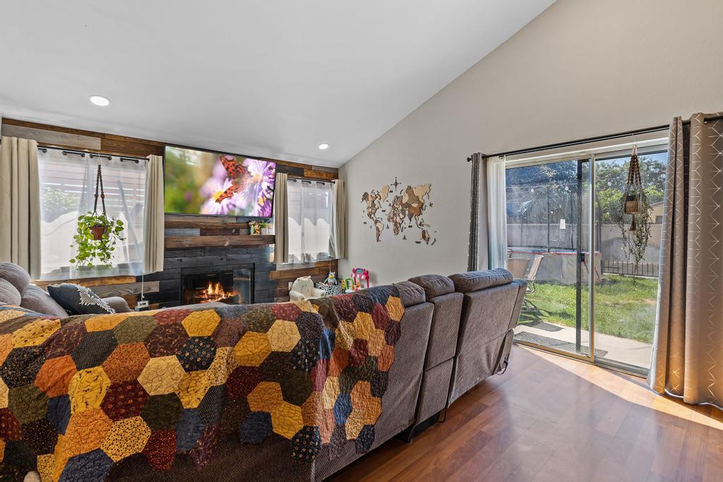 7017 Broadway Whittier, CA 90606 - Photo 14 of 32 a living room with furniture a flat screen tv and a fireplace