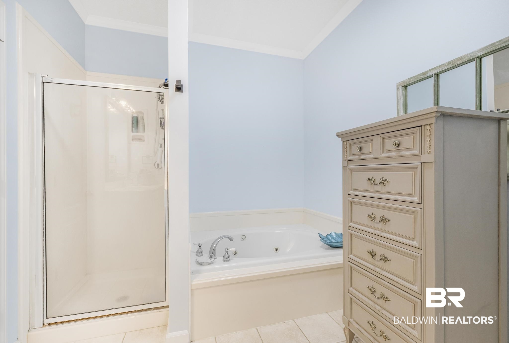10603 Old Stage Road Stockton, AL 36579 - Photo 22 of 34 Bathroom with a stall shower, a tub with jets, light tile patterned floors, and ornamental molding