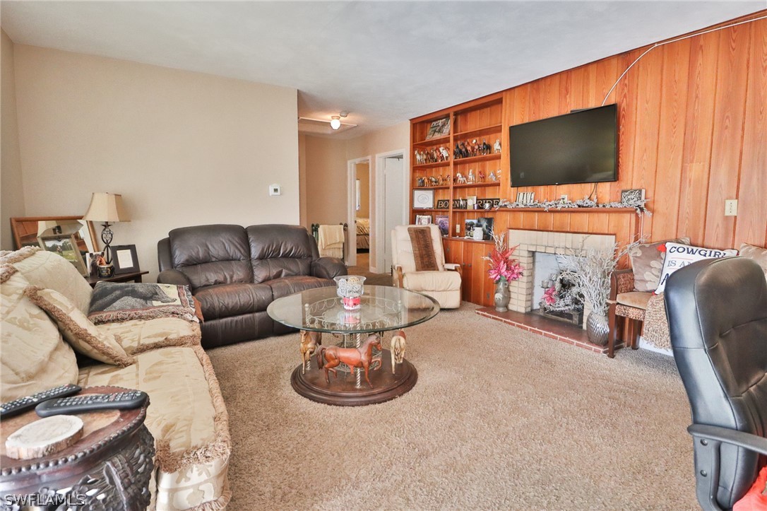 4260 Staley Road Fort Myers, FL 33905 - Photo 5 of 16 a living room with furniture a flat screen tv and a fireplace