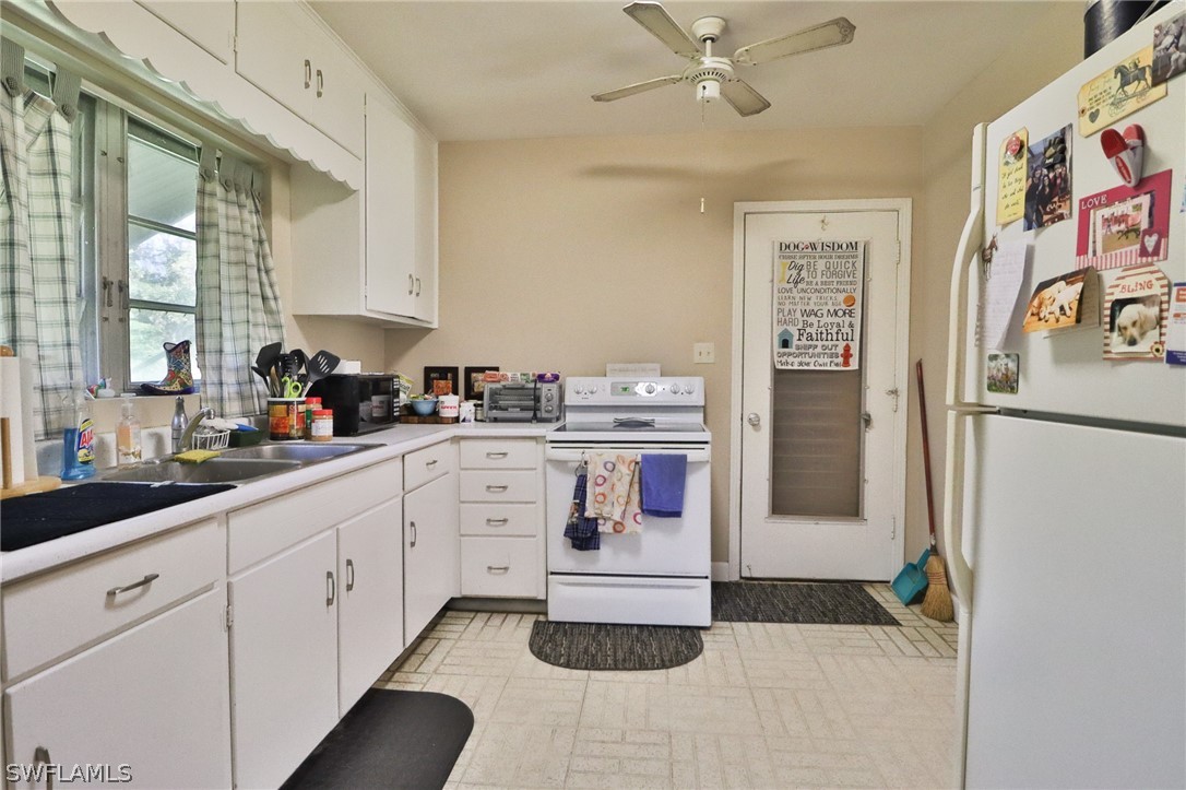 4260 Staley Road Fort Myers, FL 33905 - Photo 7 of 16 a kitchen with stainless steel appliances granite countertop a sink and cabinets