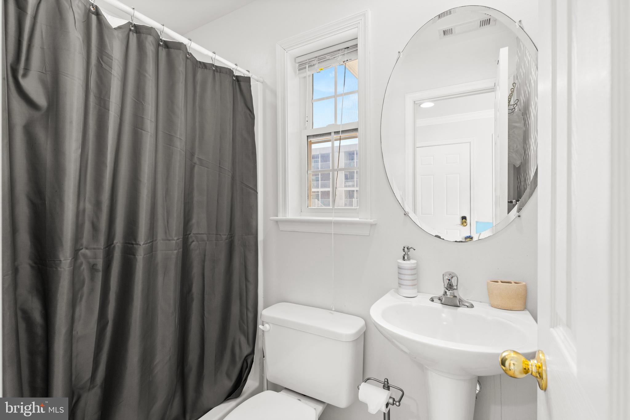 617 Salt Spray Road, Unit B Ocean City, MD 21842 - Photo 28 of 72 a bathroom with a sink a toilet and mirror