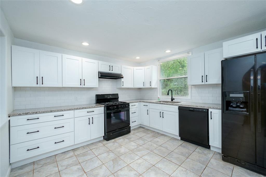 103 McJunkin Road Pittsburgh, PA 15239 - Photo 12 of 24 a kitchen with granite countertop cabinets and steel stainless steel appliances