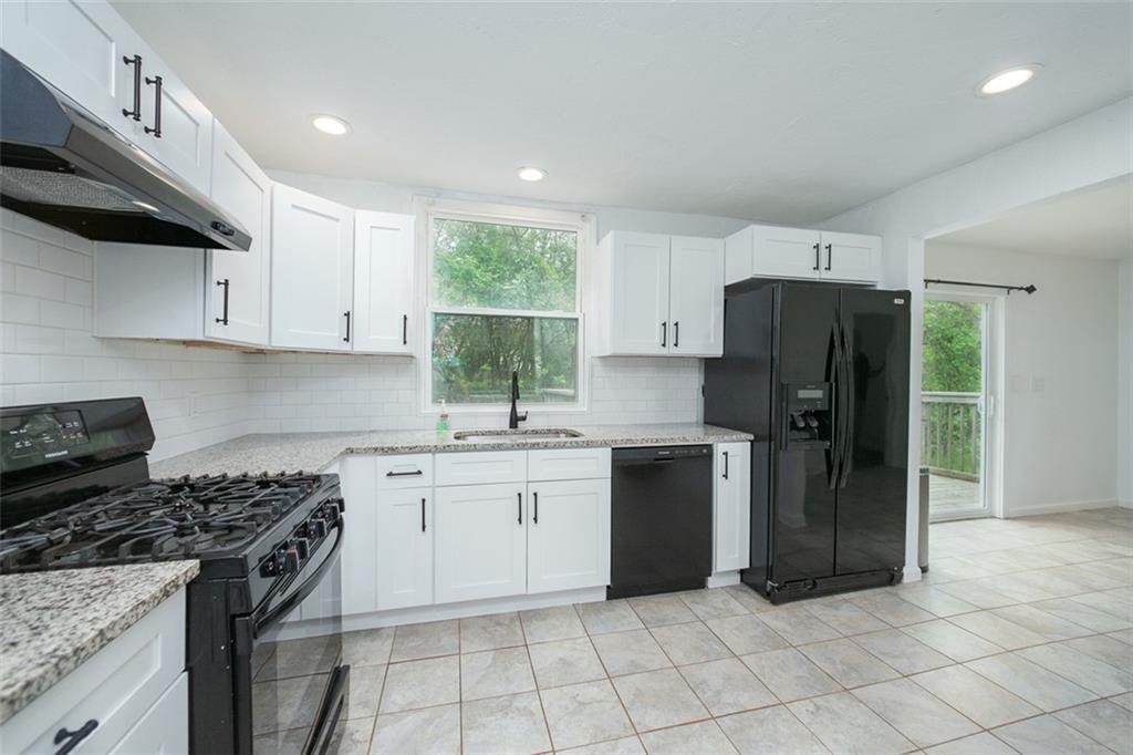 103 McJunkin Road Pittsburgh, PA 15239 - Photo 14 of 24 a kitchen with a stove a refrigerator and a sink