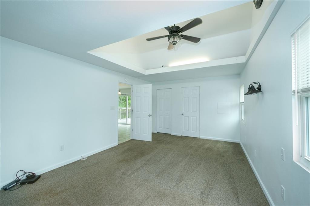 103 McJunkin Road Pittsburgh, PA 15239 - Photo 18 of 24 an empty room with a ceiling fan and carpet