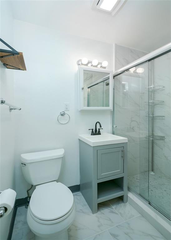 103 McJunkin Road Pittsburgh, PA 15239 - Photo 20 of 24 a bathroom with a toilet sink vanity and mirror