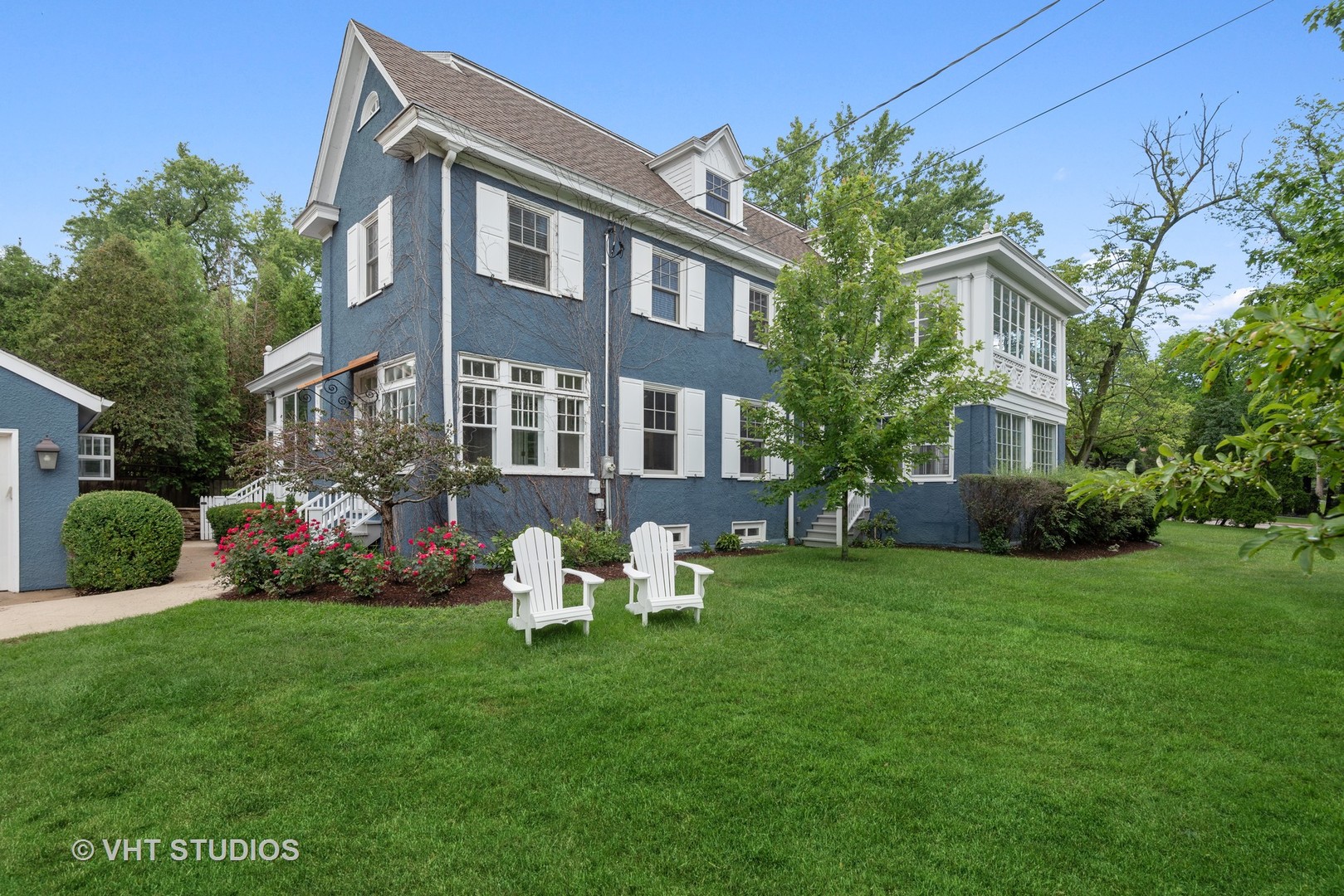 a front view of a house with garden and porch
