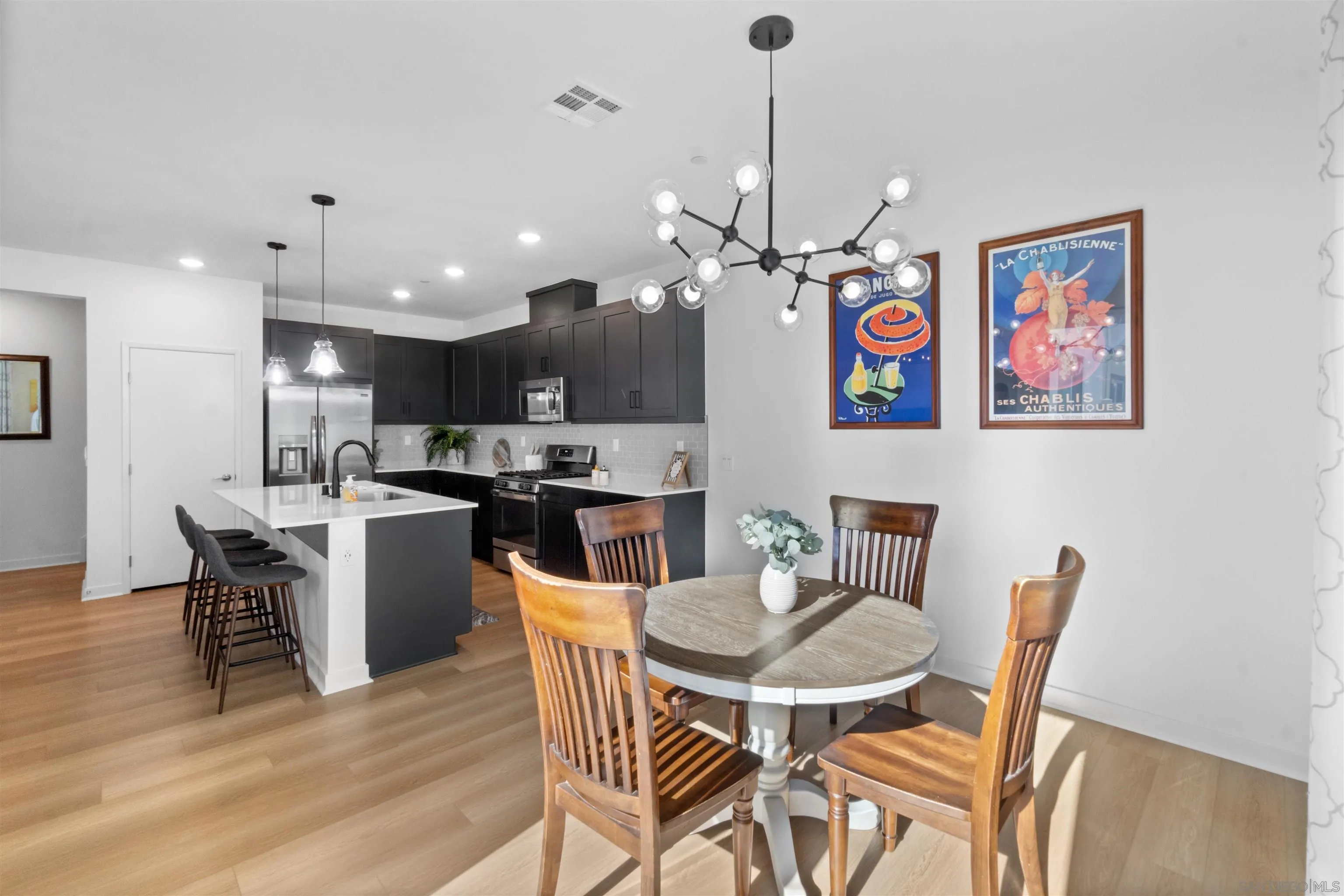 211 Canopy Trails Place Fallbrook, CA 92028 - Photo 11 of 29 a view of a dining room with furniture wooden floor and a chandelier
