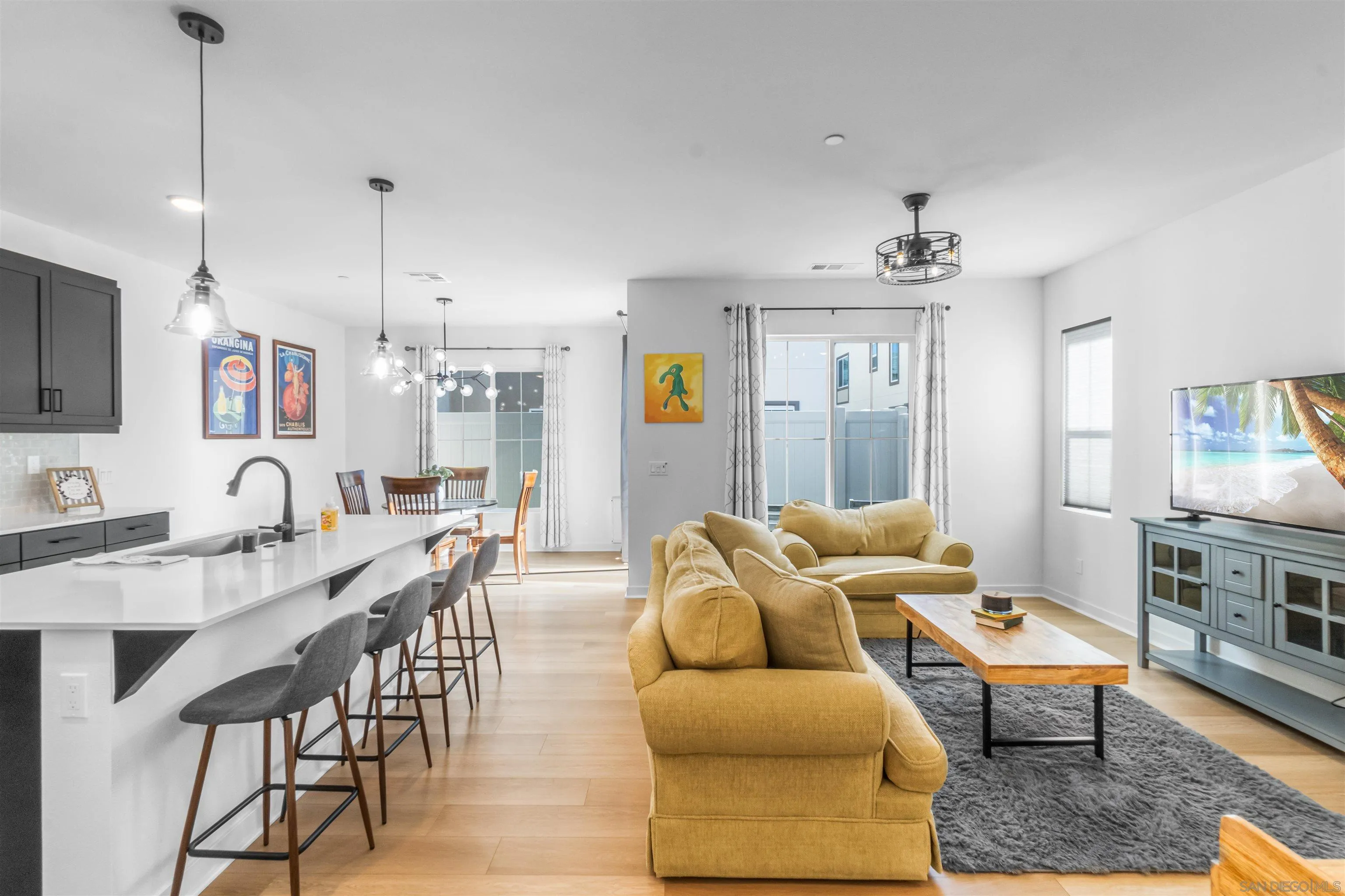 211 Canopy Trails Place Fallbrook, CA 92028 - Photo 4 of 29 a living room with furniture kitchen view and a wooden floor